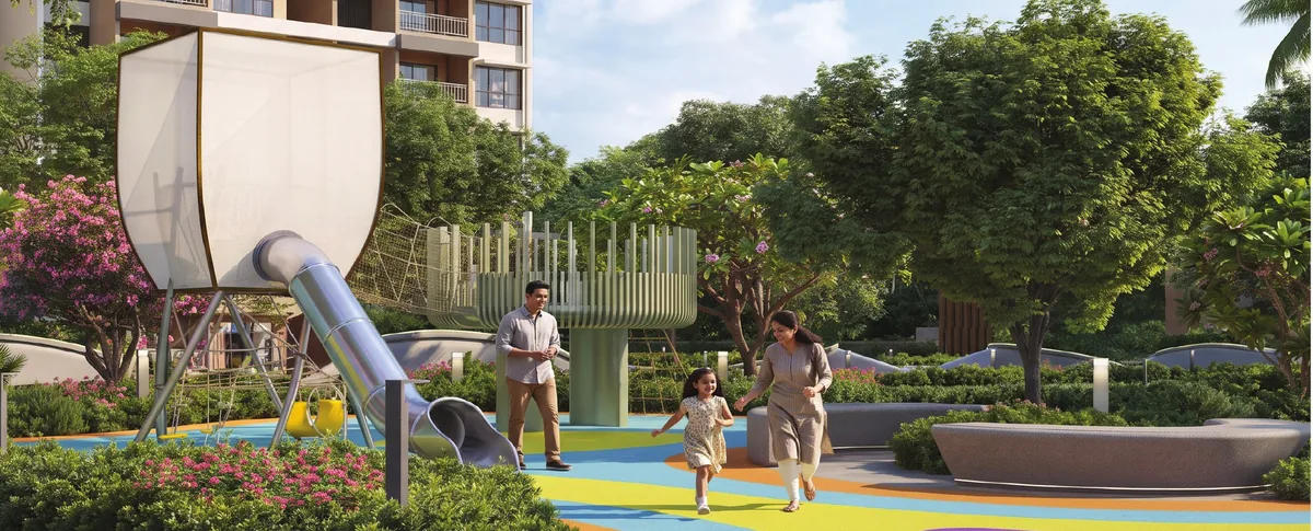 Family walking through the colourful kids play area with a slide tower at Prestige Parklane