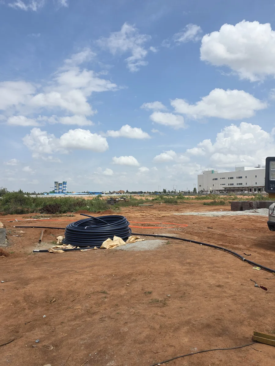 Cleared land parcel with HDPE service ducting at Prestige Park Lane, KIADB Aerospace Park Phase 2, Devanahalli, August 2026